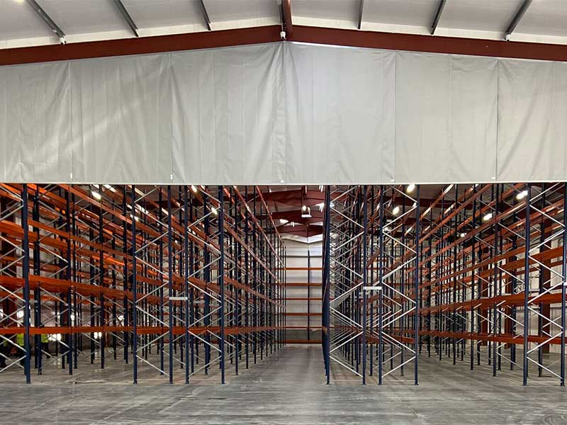 How do industrial shelves and racks improve the storage capacity of warehouses?